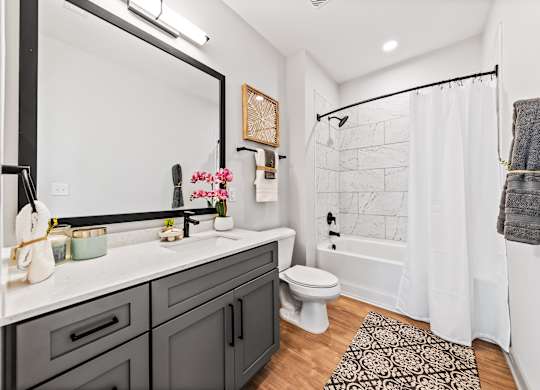 A bathroom with a white toilet and a white shower curtain.
