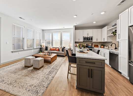 A modern kitchen with a dining area and a living room.
