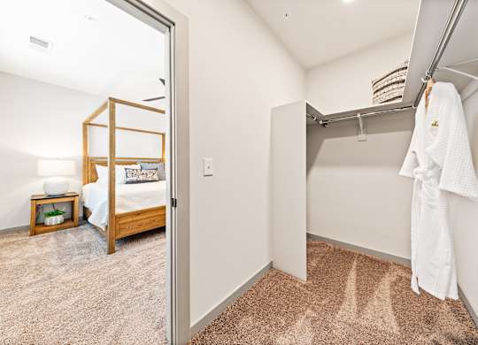 A white towel is hanging on a rack in a room.