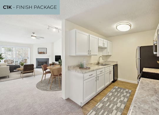 A kitchen with white cabinets and a marble countertop.