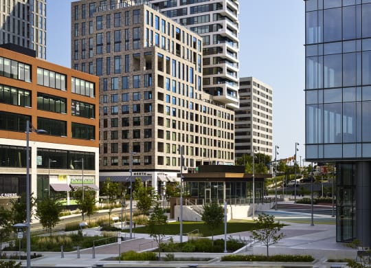a cityscape with tall buildings and a street in the foreground at The Boro, Tysons, VA 22102