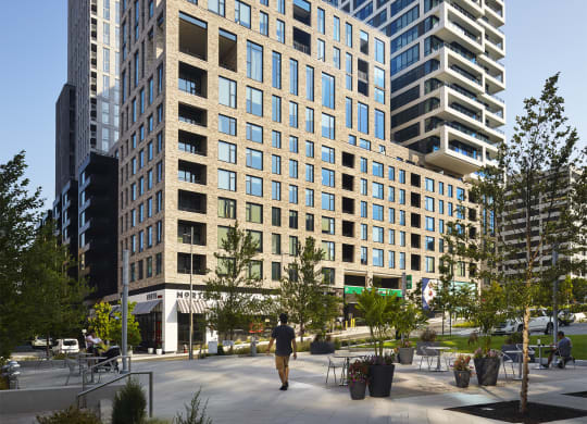 a cityscape with tall buildings and a street in the foreground at The Boro, Tysons, 22102