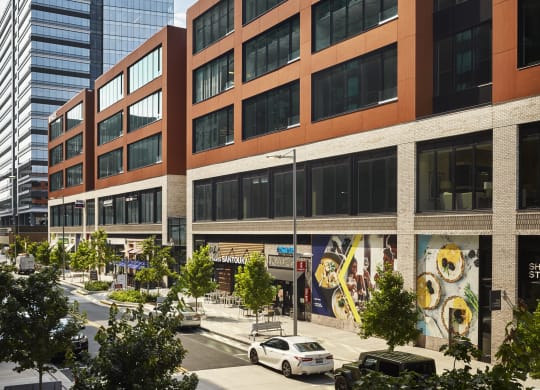 a large brick building with many windows and a street in front of it at The Boro, Tysons, VA