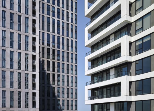 a close up of two tall buildings with balconies at The Boro, Tysons, VA