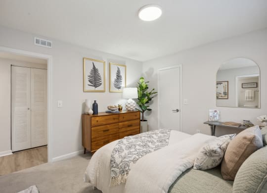 a bedroom with a bed and a closet at St. Andrews Reserve, North Carolina, 28412