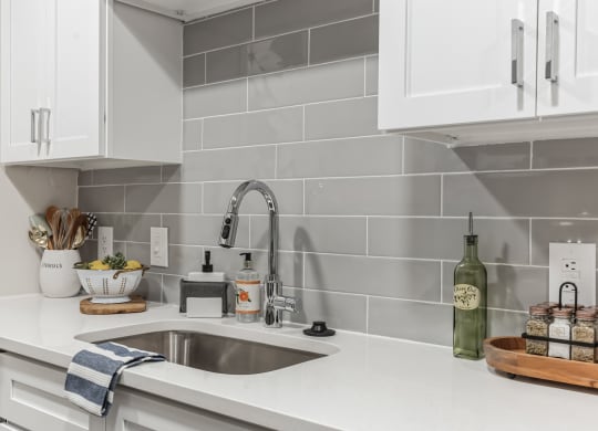 a kitchen with white counter tops and a sink at St. Andrews Reserve, Wilmington, NC