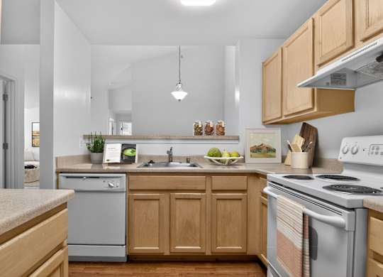 A kitchen with wooden cabinets and a stove top oven.