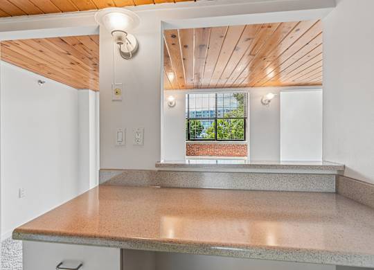 A kitchen with a counter top and a window.