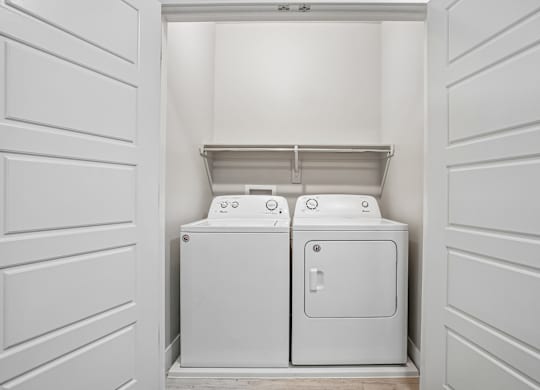 A white toilet and sink in a small white room.