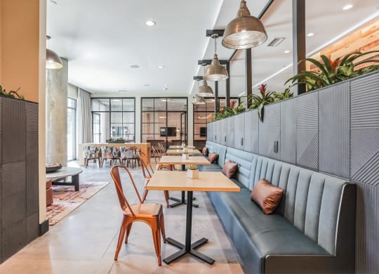 a seating area with tables and couches in a restaurant at Hawkins Press, Charlotte, North Carolina