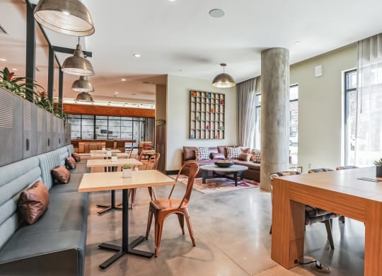 the lobby of a restaurant with tables and chairs and couches at Hawkins Press, North Carolina
