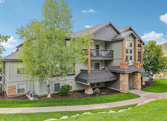 A large house with a grey exterior and a balcony.
