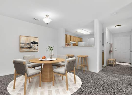 A dining room with a round table and chairs.