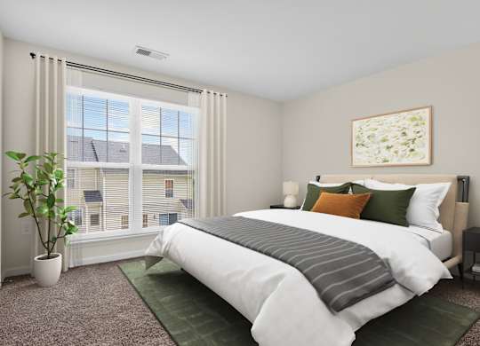 A bedroom with a large bed and a potted plant.