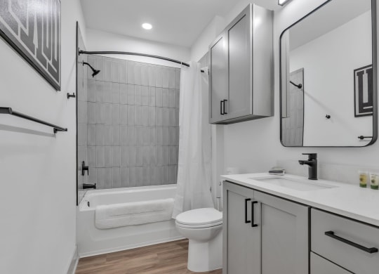 a bathroom with a shower and a sink and a toilet