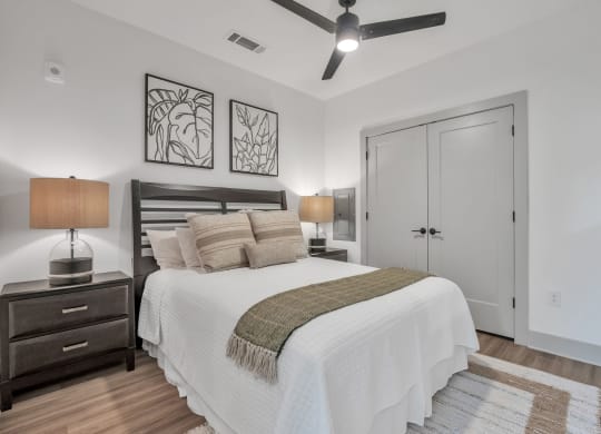 a bedroom with a bed and a ceiling fan