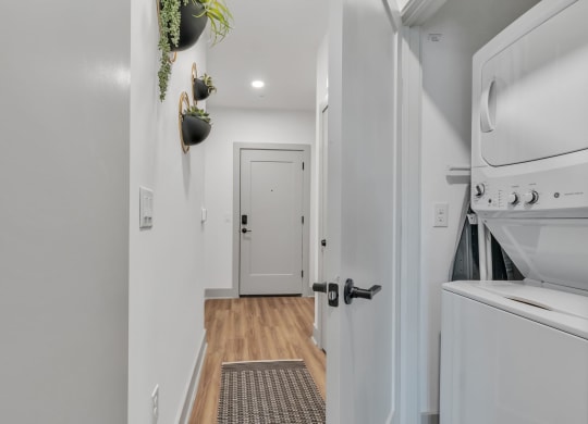 a laundry room with a washer and dryer and a white door