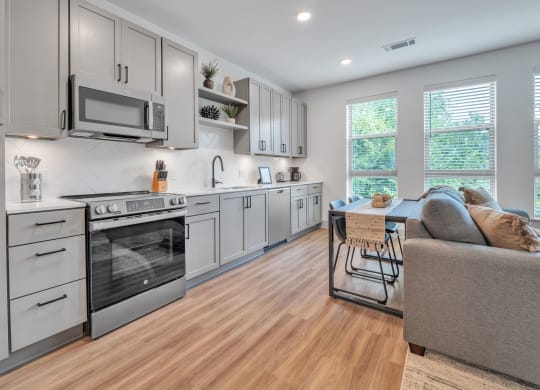 an open kitchen and living room with a couch and a table