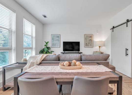 a living room with a couch and a table with chairs