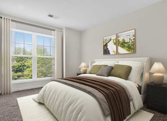 A bedroom with a large bed and a window with curtains.