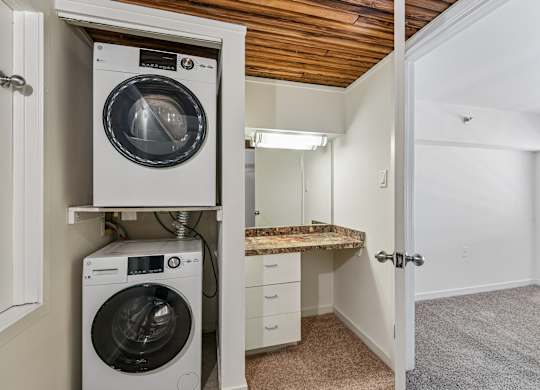 A small laundry room with a washer and dryer in it.