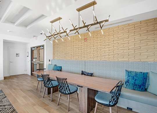 A modern dining room with a wooden table and chairs.