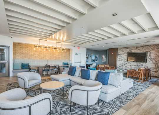 A spacious living room with a stone fireplace and a variety of seating options.
