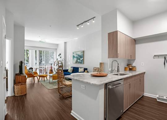 A modern kitchen with a large island and wooden floors.