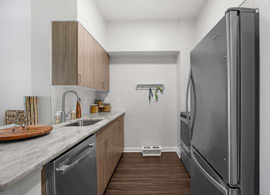 A modern kitchen with a refrigerator on the right.