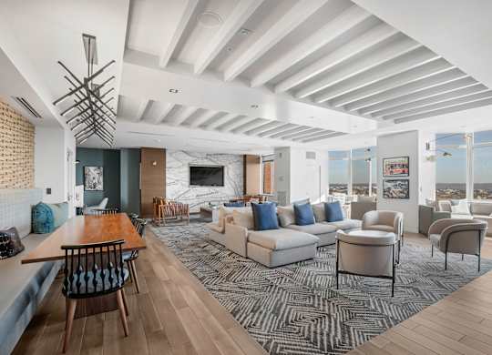 A modern living room with a wooden floor and a large window.
