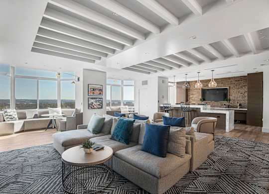 A living room with a grey couch and a coffee table.