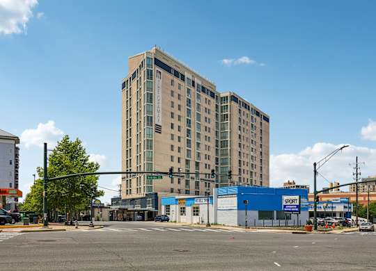 A large building with a blue Sport store in front.
