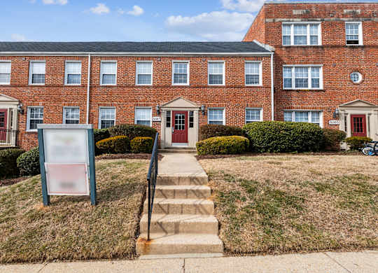 A brick building with a sign in front of it.