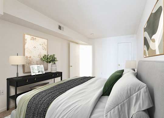 A bedroom with a bed, nightstand, and a painting on the wall at The Fields of Bethesda, Chevy Chase, MD
