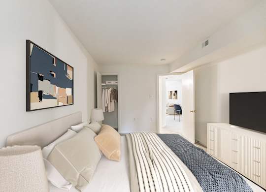 A bedroom with a bed, a lamp, and a painting on the wall at The Fields of Rockville, Rockville, 20850
