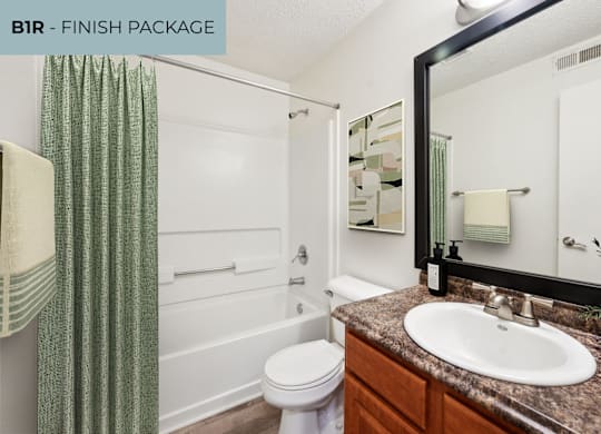 A bathroom with a white toilet, a sink, and a shower.