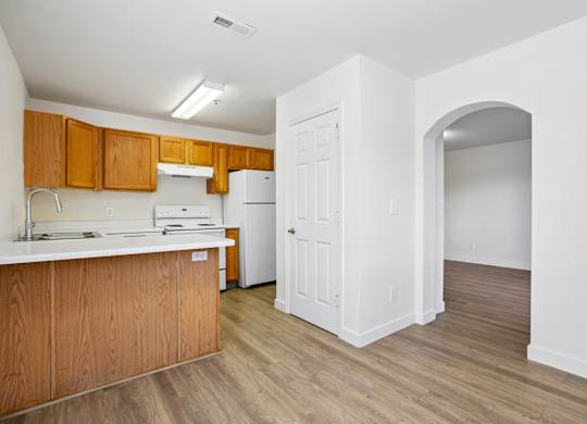 A kitchen with wooden cabinets and a white countertop.
