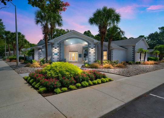 a house with a sidewalk and palm trees in front of it at St. Andrews Reserve, North Carolina, 28412