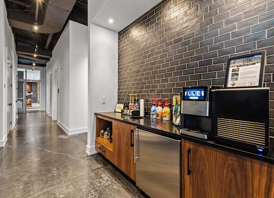 a kitchen with a counter and a microwave and a brick wall at South and Hollis, North Carolina