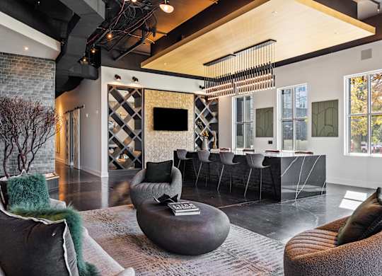 a living room with couches and a bar and a television  at South and Hollis, Charlotte, 28209