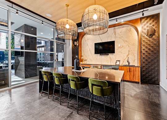 a kitchen with a marble counter top and green chairs at South and Hollis, North Carolina
