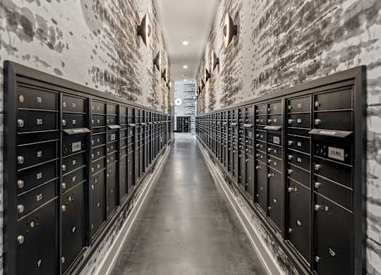 a long hallway with rows of filing cabinets in a data center with white brick walls  at South and Hollis, Charlotte, NC, 28209