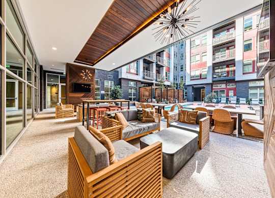a lounge area with couches and chairs and a large window