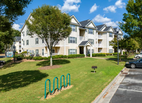 an apartment building with a green park in front of it at Alexander Ridge Apartments, Georgia, 30114