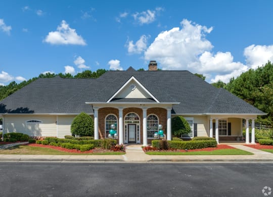 a large white house with a porch and a driveway at Alexander Ridge Apartments, Canton , GA 30114