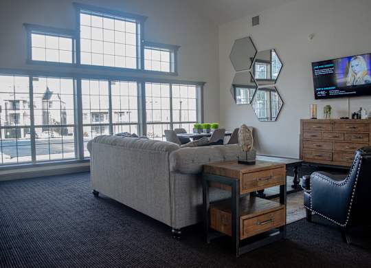 A living room with a large window overlooking a cityscape at Arrowhead Ridge Apartments, Rio Rancho