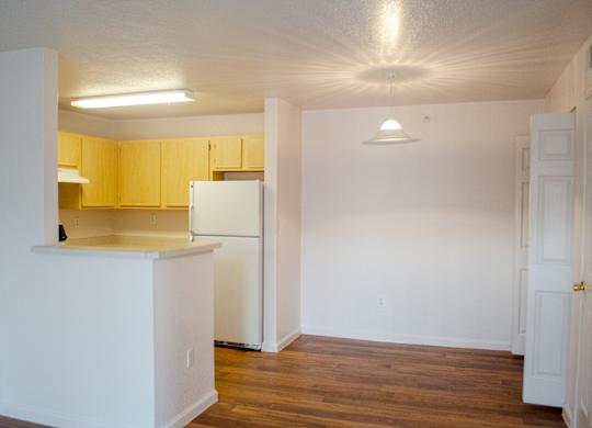 A kitchen with white cabinets and a white refrigerator at Arrowhead Ridge Apartments, Rio Rancho, NM, 87124
