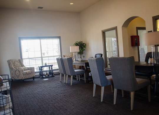 A room with a table and chairs and a plant at Arrowhead Ridge Apartments, Rio Rancho