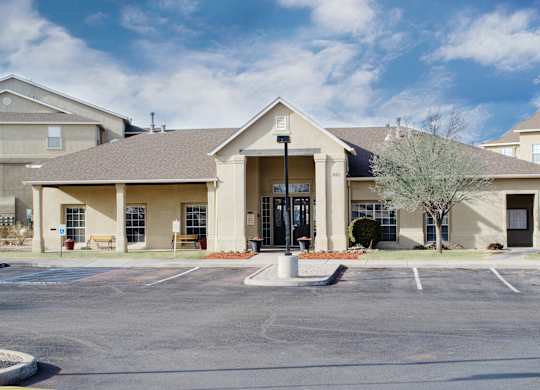 A building with a parking lot in front of it at Arrowhead Ridge Apartments, Rio Rancho, 87124