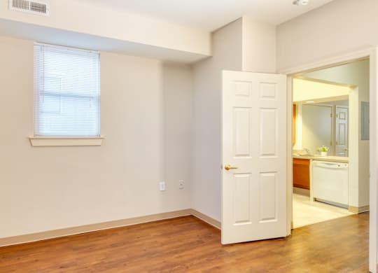 a bedroom with a door and a bathroom with a mirror at North Market South Carroll, Frederick, MD 21701